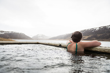 Image showing Beautiful girl in a hot pot in Iceland during winter