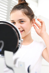 Image showing Invisible hearing aid. The hearing aid for a child.