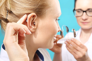 Image showing Woman listen to sound. Recovery of hearing. Happy woman listens to a whisper.