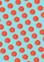 Image showing Grapefruit pattern on blue background. Minimal flat lay concept.