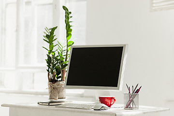 Image showing Stylish workspace with computer on home or studio