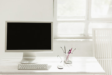 Image showing Stylish workspace with computer on home or studio