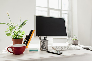 Image showing Stylish workspace with computer on home or studio