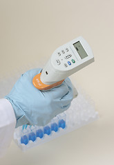 Image showing Hand holding pipette
