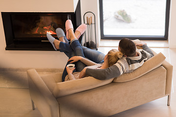 Image showing Young couple  in front of fireplace