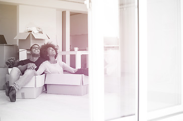 Image showing African American couple  playing with packing material