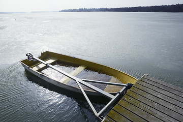 Image showing a boat flooded with water at the pier