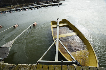 Image showing a boat flooded with water at the pier