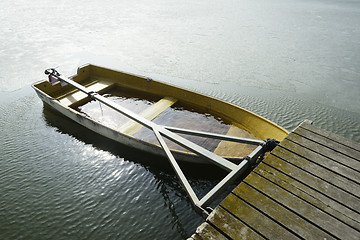 Image showing a boat flooded with water at the pier