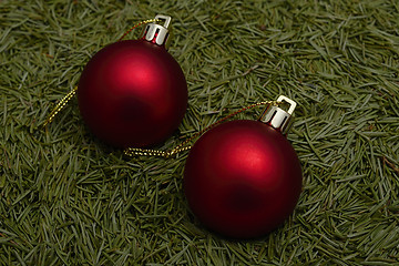 Image showing two Christmas balls on green fur-tree needles