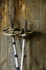 Image showing old vintage ski poles on a wooden