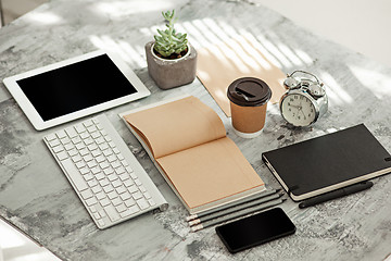 Image showing Office desk table with computer, supplies and phone