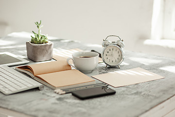 Image showing Office desk table with computer, supplies and phone