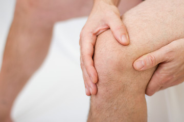 Image showing Man holding his knee