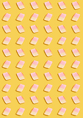 Image showing white marshmallows on a yellow background. geometric pattern of white marshmallows. top view