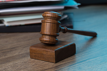 Image showing Wooden table with hammer, papers