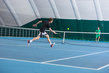 Image showing The young man in a closed tennis court with ball