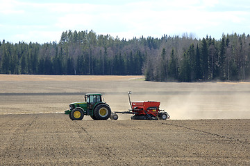 Image showing John Deere Tractor and Seeder at Work on Field