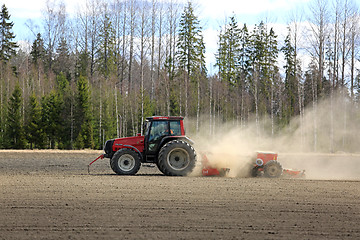 Image showing Farmer Cultivates Field at Spring