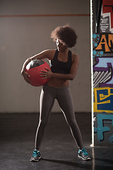 Image showing black woman carrying crossfit ball