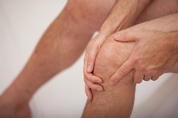 Image showing Man holding his knee