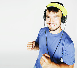 Image showing young asian man in hat and headphones listening music on white b