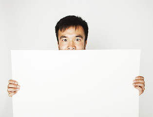 Image showing pretty cool asian man holding empty white plate smiling