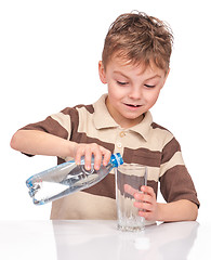 Image showing Little boy with plastic bottle of water