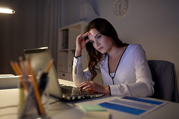 Image showing businesswoman with laptop at night office