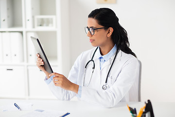 Image showing doctor with tablet pc and clipboard at hospital