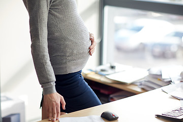 Image showing pregnant businesswoman with computer at office