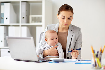 Image showing happy businesswoman with baby and laptop at office