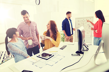 Image showing happy creative team rinking coffee at office