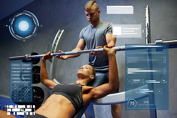 Image showing man and woman with barbell flexing muscles in gym