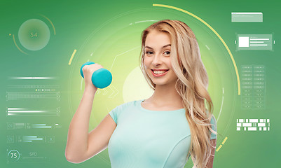 Image showing smiling beautiful young sporty woman with dumbbell