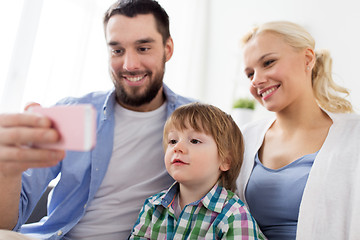 Image showing happy family with smartphone at home