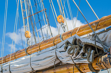 Image showing Folded sail and mast on an old sailboat