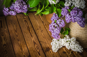 Image showing Still-life with a bouquet of lilacs and a straw hat, close-up