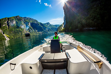 Image showing Woman driving a motor boat