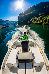 Image showing Woman driving a motor boat