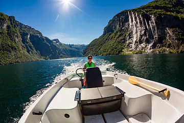 Image showing Woman driving a motor boat