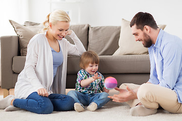 Image showing happy family playing with ball at home