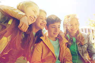 Image showing happy teenage students or friends outdoors