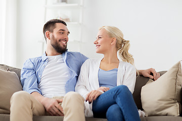 Image showing smiling happy couple sitting on sofa at home