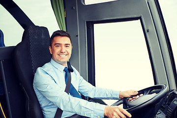 Image showing happy driver driving intercity bus