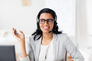 Image showing businesswoman with headset talking at office