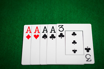 Image showing poker hand of playing cards on green casino cloth