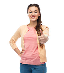 Image showing happy smiling young woman showing thumbs up