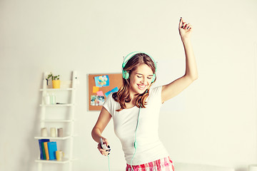 Image showing happy woman in headphones ihaving fun at home