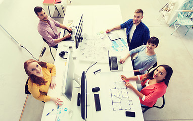 Image showing creative team with computers, blueprint at office